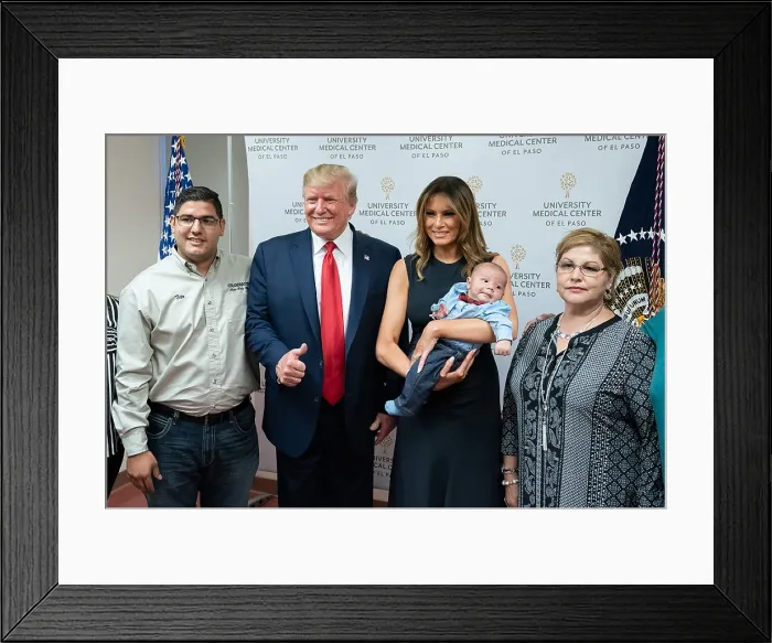 Framed Print : First Lady Melania Trump holds the orphaned, two-month-old Paul, son of Jordan and Andre Anchondo, who were killed in the mass shooting at an El Paso Wal-Mart on August 3, 2017