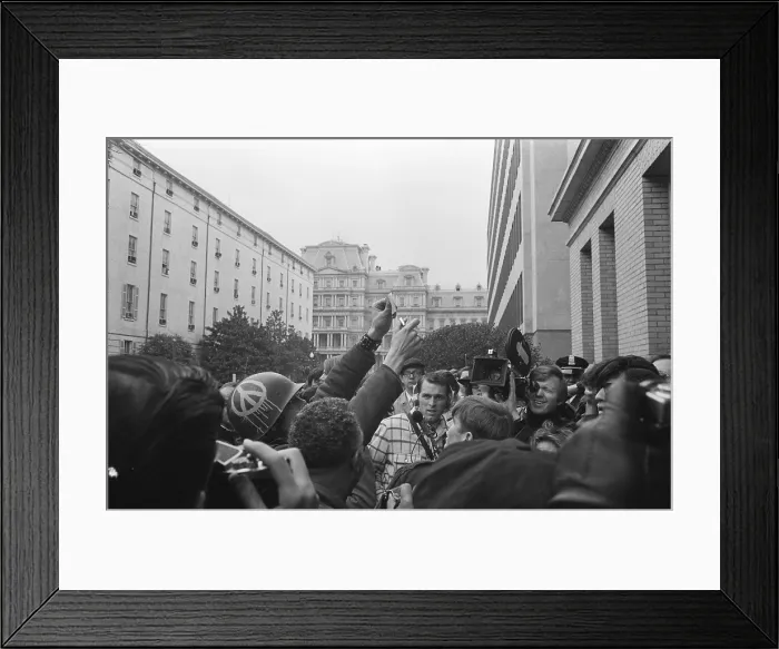 Framed Print : Young American man wearing a helmet with a peace sign burning his draft card, March 19, 1970