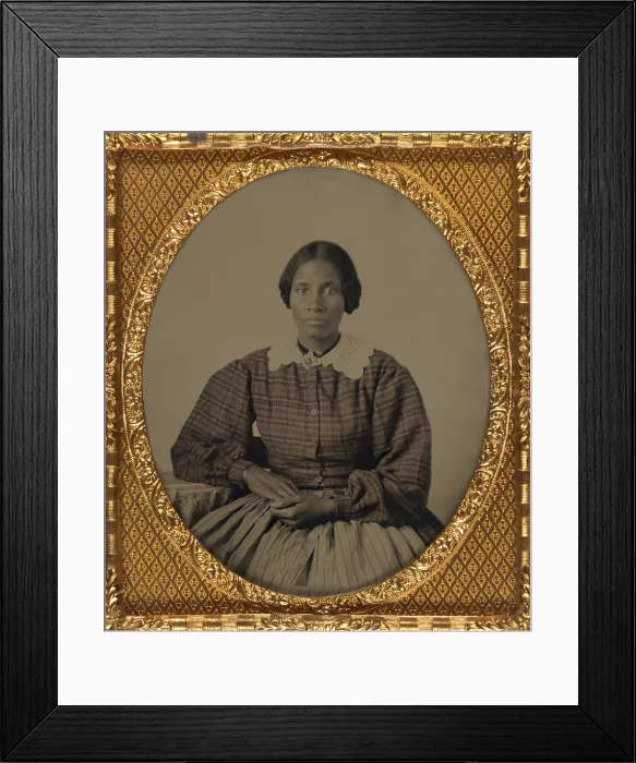 Framed Print : Fashionable dressed, pretty, young, African American woman of the 1860s. The ambrotype show her gracefully posed, wearing a plaid dress with full long sleeves and a lace collar Framed Print : Fashionable dressed, pretty, young, African American woman of the 1860s. The ambrotype show her gracefully posed, wearing a plaid dress with full long sleeves and a lace collar