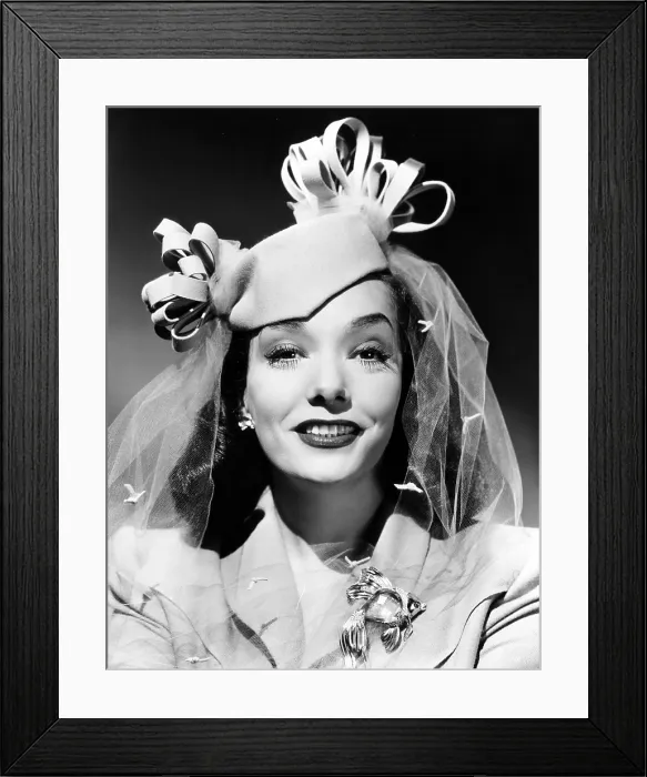 Framed Print : MEXICAN SPITFIRE'S BABY, Lupe Velez, in a beige felt pillbox and a gold brooch set with aquamarine, rubies and diamonds, ph: Ernest A. Bachrach, 1941