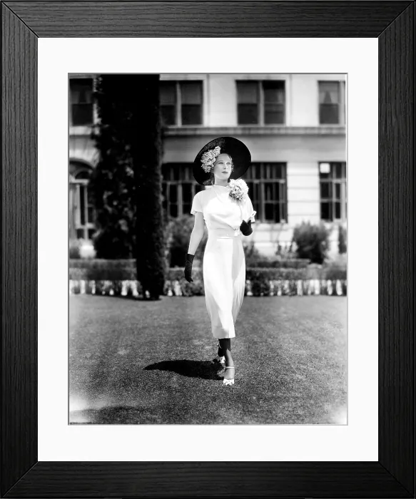 Framed Print : YOURS FOR THE ASKING, Dolores Costello, in a white frock with straw hat and violet corsages by Travis Banton, 1936