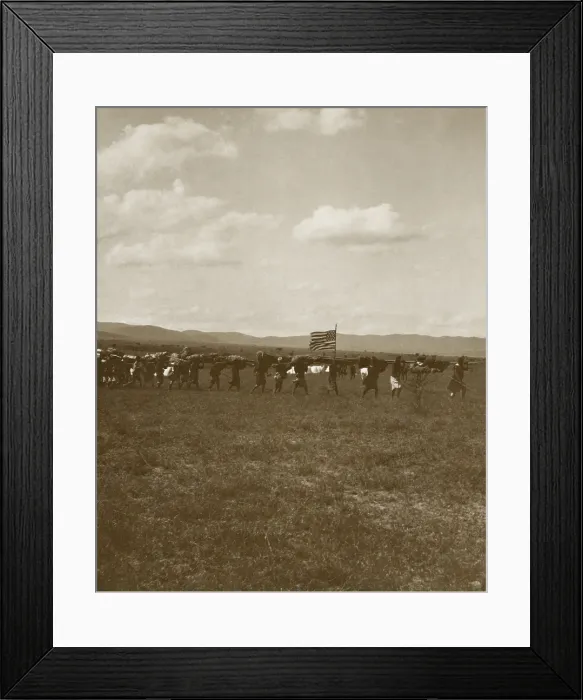 Framed Print : American flag flies on the Smithsonian-Roosevelt African Expedition, June 1909. African porters carry supplies and equipment near Nairobi with the safari camp in the background