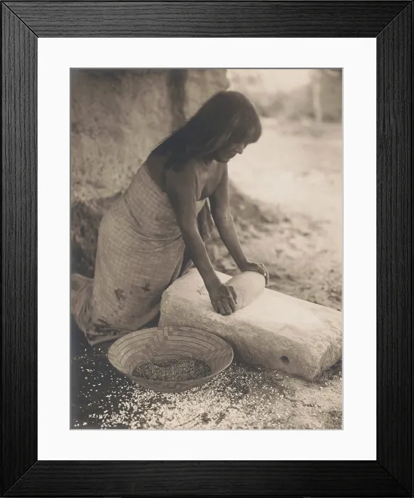 Framed Print : MARICOPA WOMAN MEALING, 1907, by Edward S. Curtis. A woman uses a Manos y Metate, a traditional tool of Central America and South America