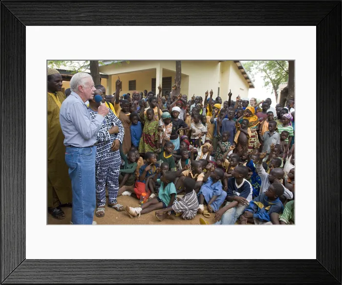 Framed Print : Former President Jimmy Carter speaks to children at Savelugu Hospital in Ghana, Feb. 8, 2007. The children with raised hands have suffered from Guinea worm disease