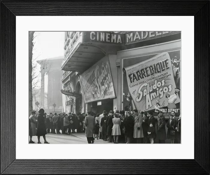 Framed Print : Parisiennes at a movie theater showing the Disney film, Saludos Amigos in April 1947. At the Madeleine Cinema, Boulevard des Capucines, Paris. - (BSLOC_2014_17_126) Framed Print : Parisiennes at a movie theater showing the Disney film, Saludos Amigos in April 1947. At the Madeleine Cinema, Boulevard des Capucines, Paris. - (BSLOC_2014_17_126)