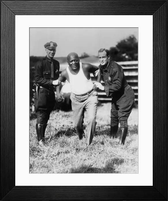 Framed Print : Jack Johnson, being held by two police officers in mock restraint, after being caught speeding in Orangeburgh, Pennsylvania, in 1929 (BSLOC_2020_2_185) Framed Print : Jack Johnson, being held by two police officers in mock restraint, after being caught speeding in Orangeburgh, Pennsylvania, in 1929 (BSLOC_2020_2_185)
