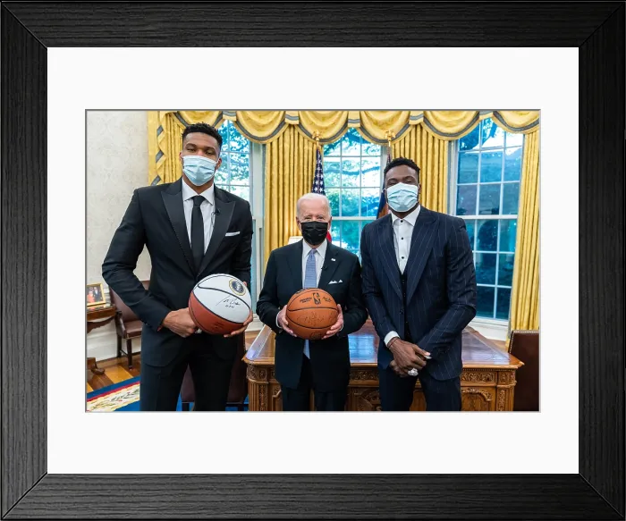 Framed Print : President Joe Biden signs a basketball and records a video message with Giannis Antetokounmpo and Thanasis Antetokounmpo of the 2021 NBA Champion Milwaukee Bucks, Nov