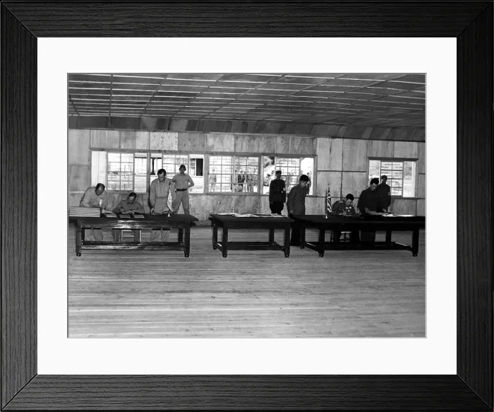 Framed Print : Gen. William Harrison, (left table) signs armistice ending the 3-year Korean conflict. At the right table, North Korean Gen. Nam II, signs documents. Panmunjom, July 23, 1953