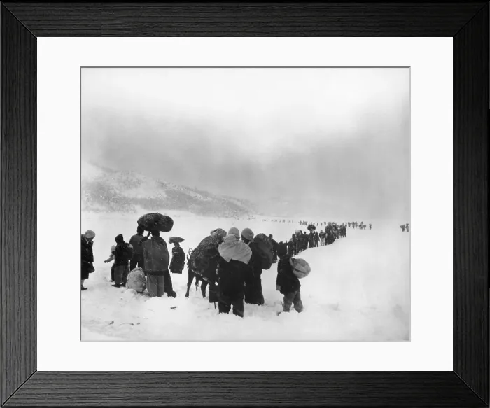Framed Print : Korean refugees slog through snow outside of Kangnung (Gangneung), moving south with bundles of belongings