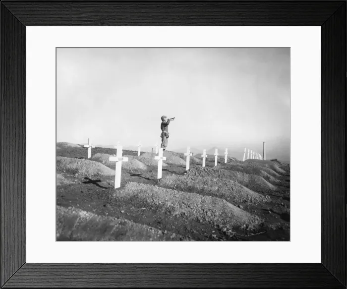 Framed Print : U.S. Marine plays Taps over the graves of fallen Leathernecks during memorial services