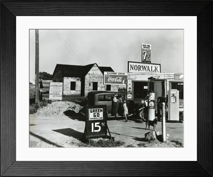 Framed Print : Store near a San Joaquin Valley shack town community of migrant workers, April 9, 1940. It sells gasoline at 15 cents a gallon and post signs for Coca Cola, 7 Up, and Pepsi soda