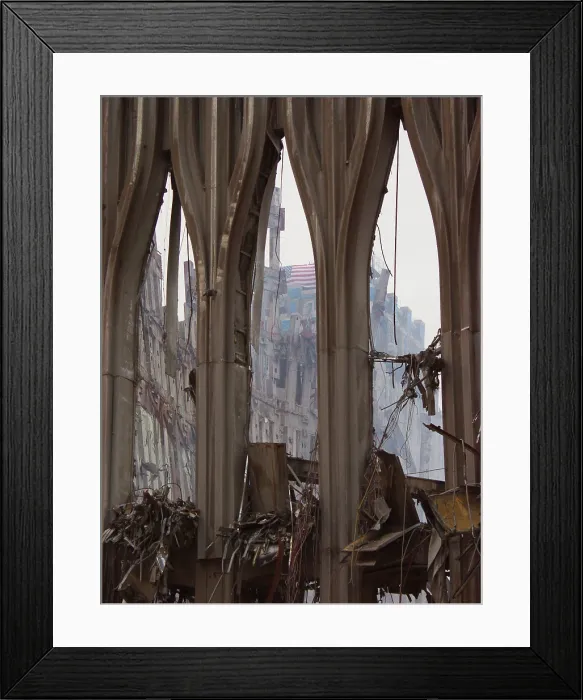 Framed Print : Fragment of the façade of WTC 1, the South Tower façade on Sept. 21, 2001. Through the center arch a flag can be seen on the damaged New York Telephone (now Verizon) Building Framed Print : Fragment of the façade of WTC 1, the South Tower façade on Sept. 21, 2001. Through the center arch a flag can be seen on the damaged New York Telephone (now Verizon) Building