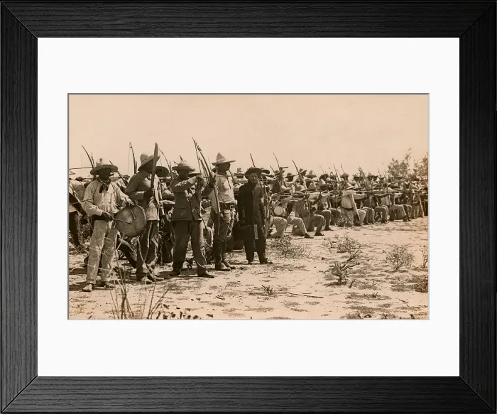 Framed Print : A formation of Mayo Indians with bows drawn during the Mexican Revolution, c. 1911-1914. At left a man beats a drum, while another raises a sword Framed Print : A formation of Mayo Indians with bows drawn during the Mexican Revolution, c. 1911-1914. At left a man beats a drum, while another raises a sword