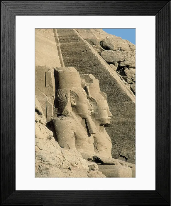 Framed Print : Great Temple of Rameses II. EGYPT. ASWAN. Abu Simbel. Great Temple of Rameses II. Upper section of two of the four colossus that flank the entrance to the Great Temple