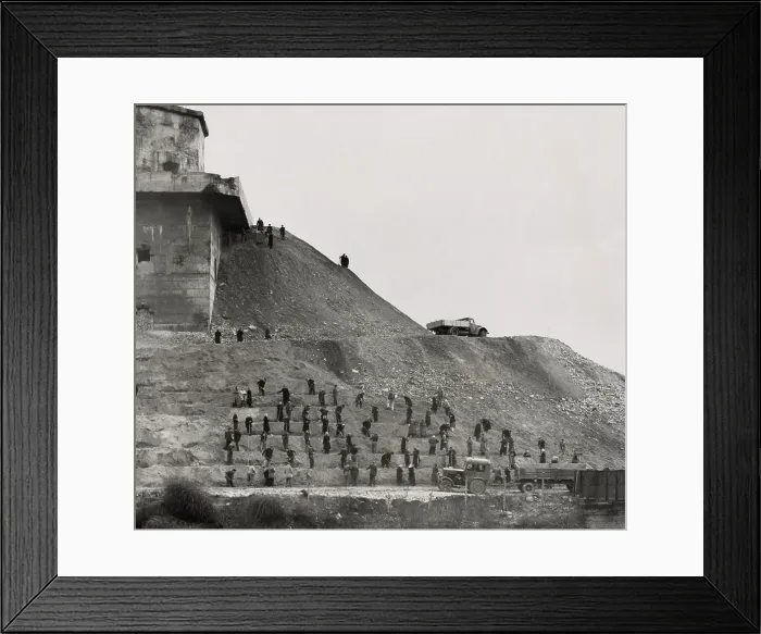 Framed Print : German workers covering a massive anti-aircraft bunker built in Berlin during World War 2. Both men and women are at work. March 4, 1951. (BSLOC_2014_13_14)