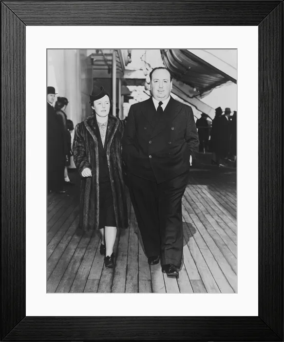 Framed Print : Alfred Hitchcock and his wife, Alma Reville, on deck of the SS Queen Mary, 1939. (BSLOC_2013_9_19) Framed Print : Alfred Hitchcock and his wife, Alma Reville, on deck of the SS Queen Mary, 1939. (BSLOC_2013_9_19)