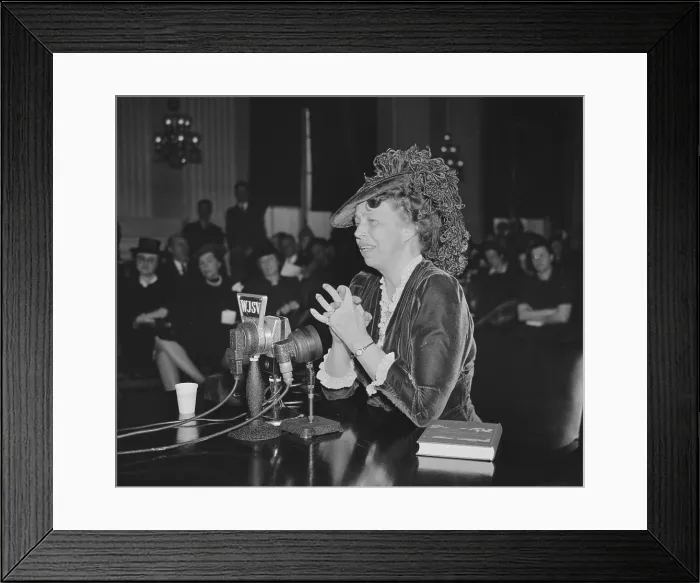 Framed Print : First Lady Eleanor Roosevelt speaking and wearing an adventurous ostrich feathered hat. 1930s. A book, The Way to Democracy, is beside her (BSLOC_2016_10_211)