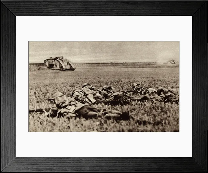 Framed Print : World War 1. Platoon of the American 107th infantry, lying low behind an advancing tank, ready to attack as soon as the tank has battered down the enemy defenses Framed Print : World War 1. Platoon of the American 107th infantry, lying low behind an advancing tank, ready to attack as soon as the tank has battered down the enemy defenses