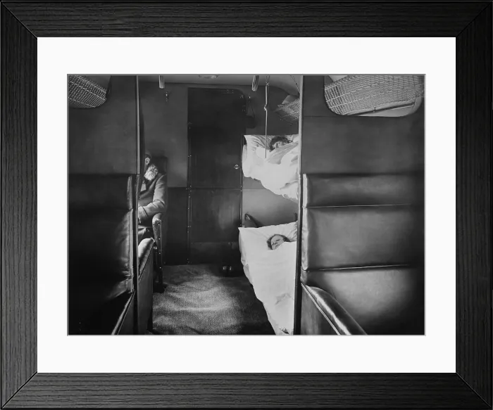 Framed Print : Interior of Junkers plane with passenger sitting in leather armchair seats. In the foreground are sleeping bunks (BSLOC_2016_10_166) Framed Print : Interior of Junkers plane with passenger sitting in leather armchair seats. In the foreground are sleeping bunks (BSLOC_2016_10_166)