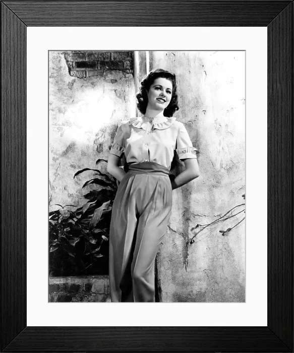 Framed Print : MISSION TO MOSCOW, Eleanor Parker, in an ivory blouse and red slacks, 1943