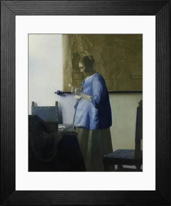 Framed Print : Woman Reading a Letter, by Johannes Vermeer, 1663, Dutch painting, oil on canvas. A young woman in a blue jacket, stands by a table with chairs Framed Print : Woman Reading a Letter, by Johannes Vermeer, 1663, Dutch painting, oil on canvas. A young woman in a blue jacket, stands by a table with chairs