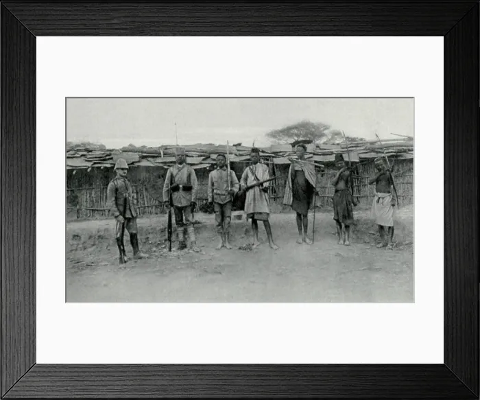 Framed Print : World War 1 in Africa. The transformation the German Askaris (native soldiers). At right are three natives with their traditional weapons