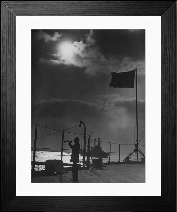 Framed Print : On the USS PENNSYLVANIA, a bugler sounds a call on the fantail, c. 1918. Other ships of the Battle Fleet are in the moonlit water (BSLOC_2016_13_166.jpg )