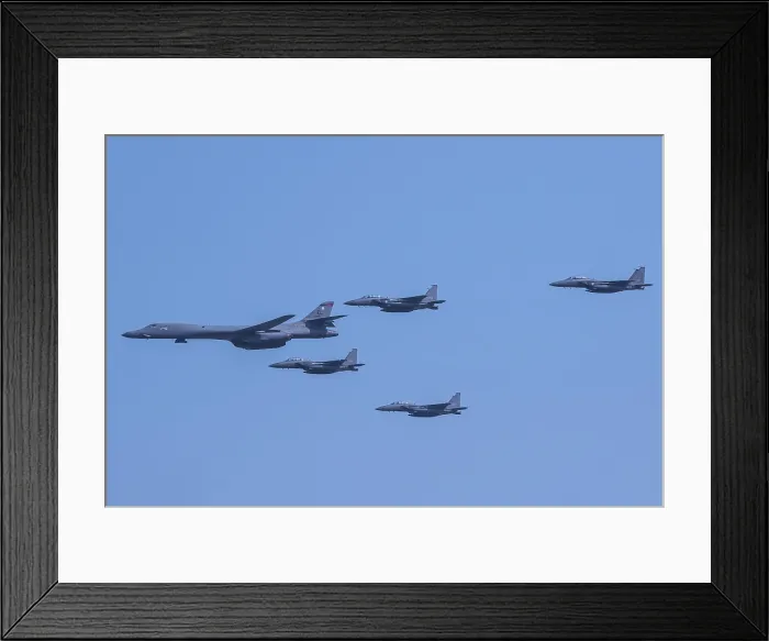 Framed Print : US Air Force B-1B Lancer, escorted by South Korean air force F-15K Slam Eagles, Sept. 13, 2016. The allied aircraft fly over Osan Air Base, South Korea, Sept