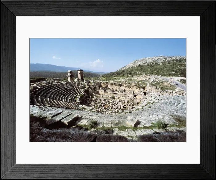 Framed Print : TURKEY. MEDITERRANEAN COAST. ANTALYA. Xanthus. Roman theatre (2nd c.). In the background on the left the funerary monument known as the Harpy Tower (480 BC). Roman art Framed Print : TURKEY. MEDITERRANEAN COAST. ANTALYA. Xanthus. Roman theatre (2nd c.). In the background on the left the funerary monument known as the Harpy Tower (480 BC). Roman art