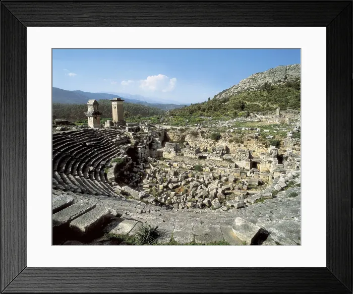 Framed Print : TURKEY. MEDITERRANEAN COAST. ANTALYA. Xanthus. Roman theatre (2nd c.). In the background on the left the funerary monument known as the Harpy Tower (480 BC). Roman art Framed Print : TURKEY. MEDITERRANEAN COAST. ANTALYA. Xanthus. Roman theatre (2nd c.). In the background on the left the funerary monument known as the Harpy Tower (480 BC). Roman art