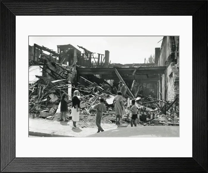 Framed Print : Store destroyed during the Detroit, Michigan, Riots of July 1967. An African American woman searches the ruins as pedestrians look on. (BSLOC_2015_14_105)