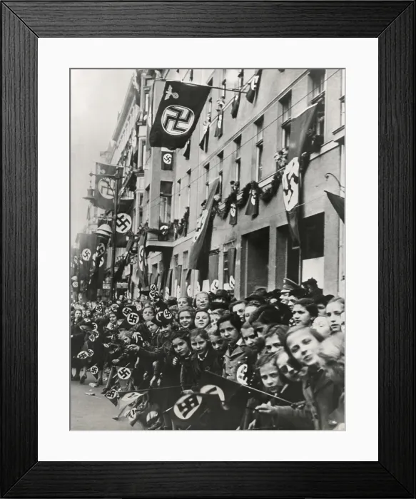 Framed Print : German children equipped with swastika flags look toward an advancing Nazi parade. Ca. 1935-1939. Unidentified location. (BSLOC_2015_13_50)