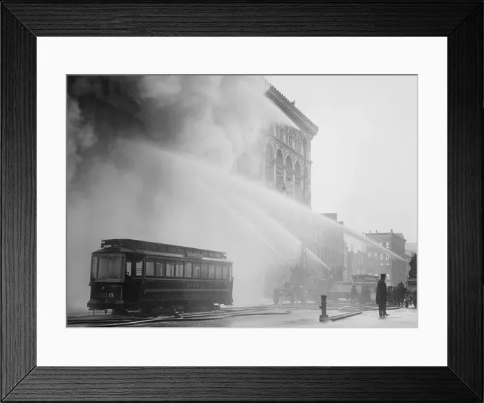 Framed Print : Firemen spraying three streams of high pressure water on a fire on 14th St. NYC, Dec. 1909. An abandoned trolley stands in the foreground (BSLOC_2017_17_101) Framed Print : Firemen spraying three streams of high pressure water on a fire on 14th St. NYC, Dec. 1909. An abandoned trolley stands in the foreground (BSLOC_2017_17_101)