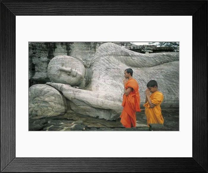 Framed Print : SRI LANKA. POLONNARUWA. Polonnaruwa. Colossal statue of Reclining Buddha (14 m.) at the Gal Vihara or Rock Temple (12th c.). Monks praying Framed Print : SRI LANKA. POLONNARUWA. Polonnaruwa. Colossal statue of Reclining Buddha (14 m.) at the Gal Vihara or Rock Temple (12th c.). Monks praying