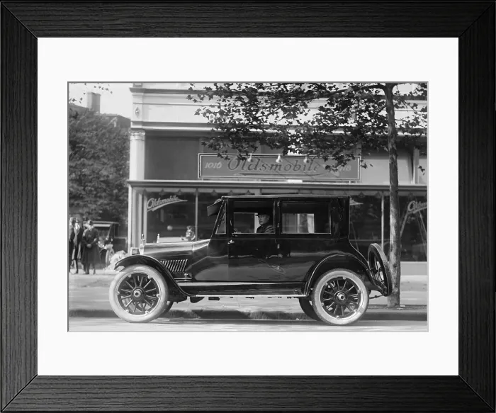 Framed Print : 1922 Oldsmobile with a four cylinder engine sold for about $1650 ($23, 600 in 2016). In the background is an Oldsmobile dealership in Washington, D.C. (BSLOC_2016_10_111)