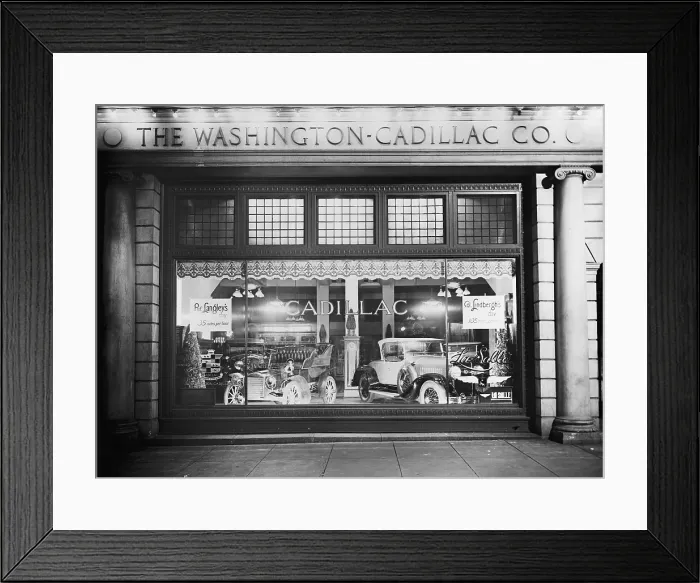 Framed Print : 1927 Cadillac LaSalle (right) shares the showroom window with a vintage model. The Washington, D.C. dealership window compares the speed of Prof