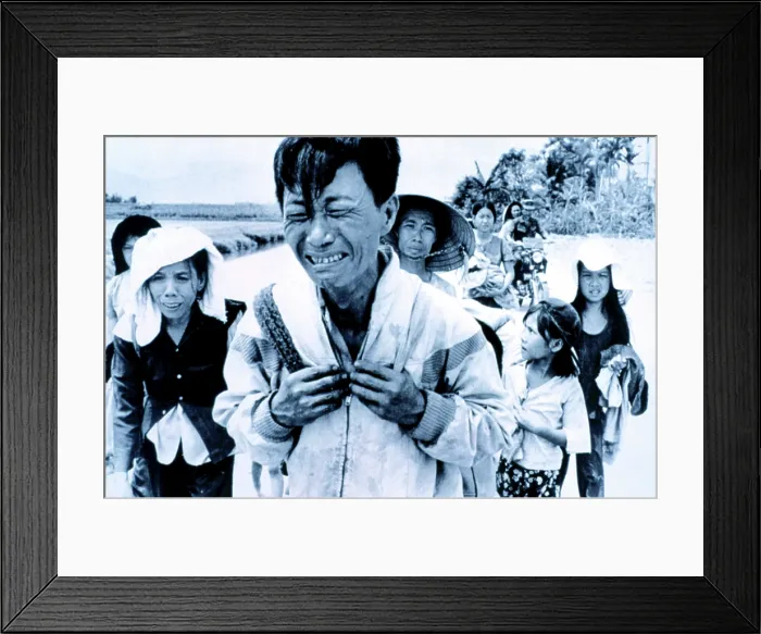 Framed Print : Vietnam War: A head of family weeps as his family is forced to migrate March 29, 1975. Courtesy: CSU Archives  /  Everett Collection