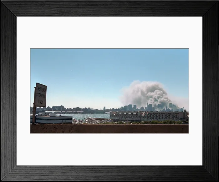 Framed Print : Smoke and pulverized building debris rise from the World Trade Center, Tuesday, Sept. 11, 2001. Photo taken from New Jersey after the North Tower collapsed at 10:28 AM Framed Print : Smoke and pulverized building debris rise from the World Trade Center, Tuesday, Sept. 11, 2001. Photo taken from New Jersey after the North Tower collapsed at 10:28 AM