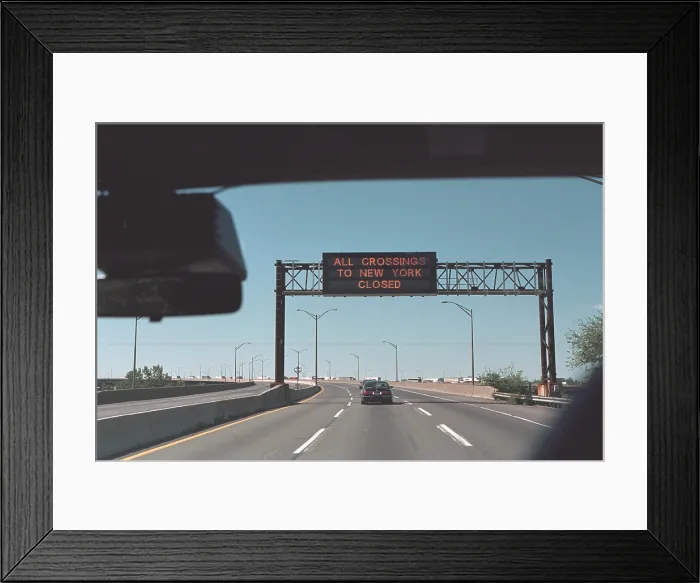 Framed Print : All Crossings to New York Closed reads a highway sign on Sept. 11, 2001