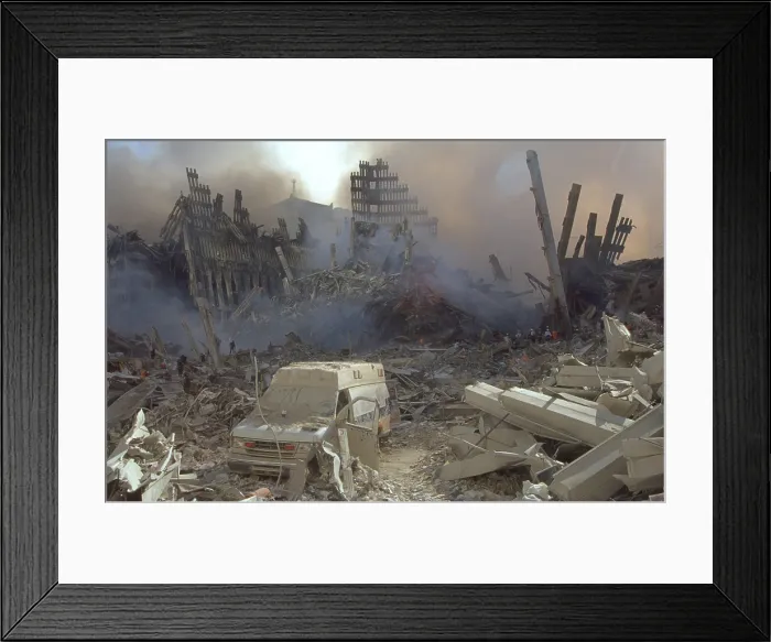 Framed Print : A dust covered ambulance in the remains of the World Trade Center on Sept 13, 2001. Emergency workers in the background are convey the scale of the ruins Framed Print : A dust covered ambulance in the remains of the World Trade Center on Sept 13, 2001. Emergency workers in the background are convey the scale of the ruins
