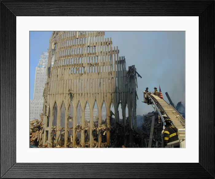 Framed Print : NYC firefighters in a bucket on an extension ladder over the remains of WTC 2, the South Tower. Sept. 16, 2001