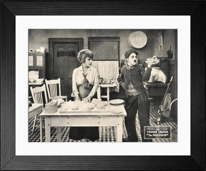 Framed Print : THE PAWNSHOP, l-r: Edna Purviance, Charlie Chaplin on lobbycard, 1916