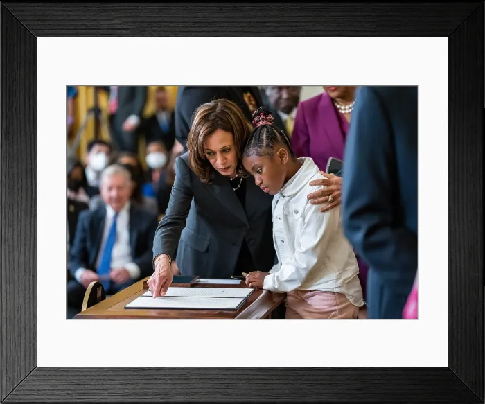 Framed Print : Vice President Kamala Harris shows Gianna Floyd, 7-year-old daughter of George Floyd, the executive order President Joe Biden signed on federal policing reforms, May 25, 2022