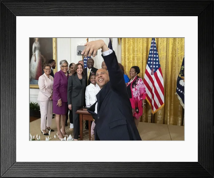 Framed Print : New Jersey Senator Cory Booker takes a group selfie after President Joe Biden signed an executive order for federal policing reforms and police accountability, May 25, 2022