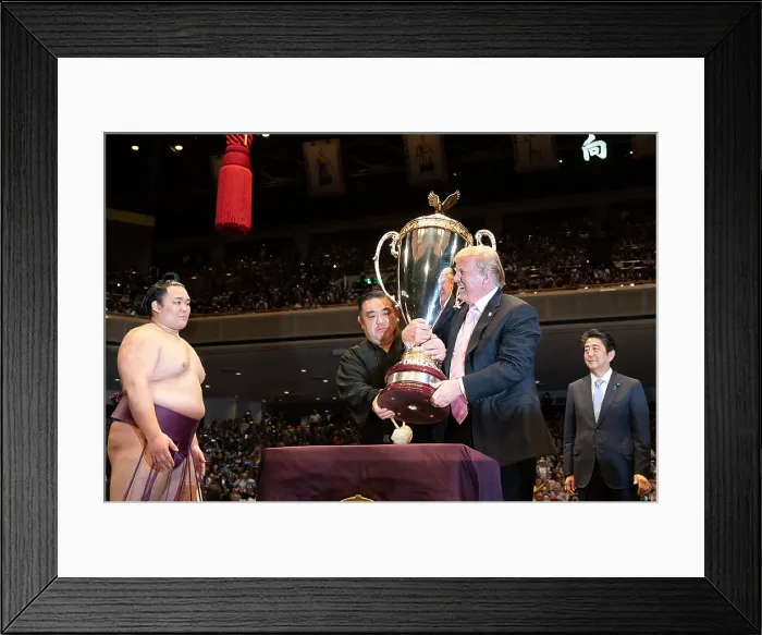 Framed Print : President Donald Trump, presents a trophy at the Sumo Grand Championship at the Ryogoku Kokugikan Stadium in Tokyo. Japan Prime Minister Shinzo Abe, is at right (BSLOC_2019_5_168)