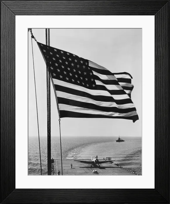 Framed Print : Flag of the United States snaps in the breeze over the USS Santee. November 1942. USS Santee was one of 4 escort carriers in Operation Torch, the Nov Framed Print : Flag of the United States snaps in the breeze over the USS Santee. November 1942. USS Santee was one of 4 escort carriers in Operation Torch, the Nov