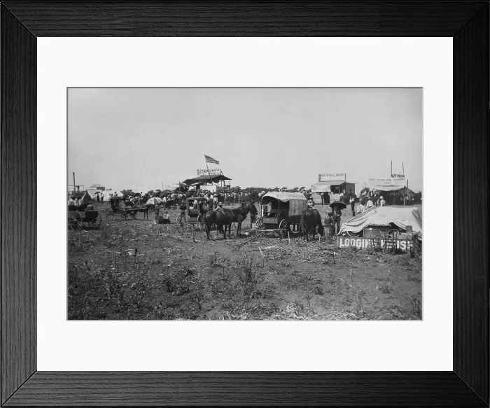 Framed Print : Land auction in progress at the lumber company booth, with banks offering their services at right