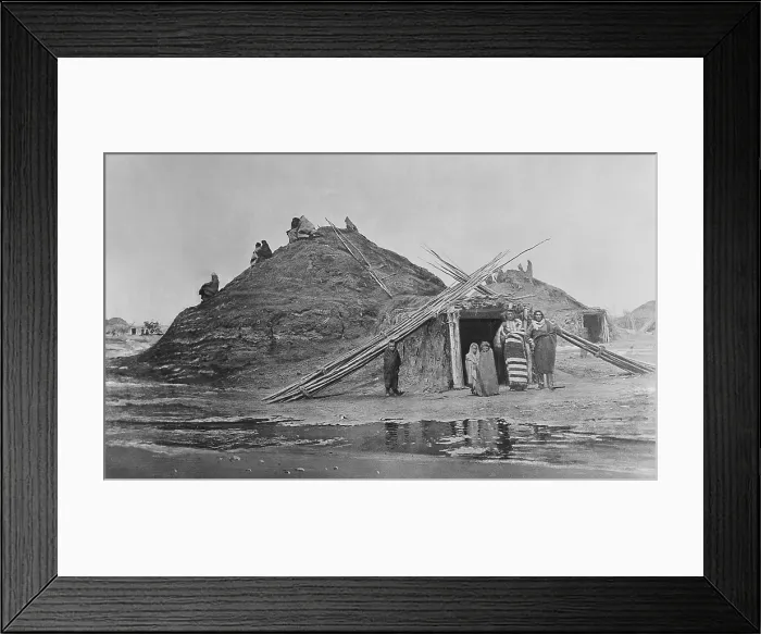 Framed Print : Pawnee lodges at Loup, Nebraska, with an Indian family standing in front of the entrance. 1873 photo by William H. Jackson