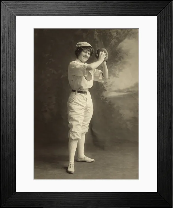 Framed Print : Studio portrait of a smiling young woman in pitching stance, wearing a baseball uniform, 1913