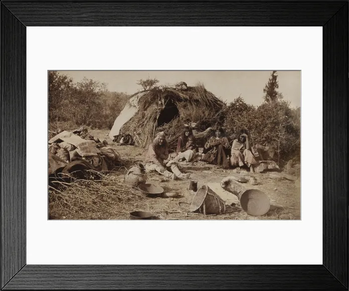 Framed Print : An Apache camp in Texas, ca. 1885, shows young women, one with a baby, and an old man, sitting outside their shelter Framed Print : An Apache camp in Texas, ca. 1885, shows young women, one with a baby, and an old man, sitting outside their shelter